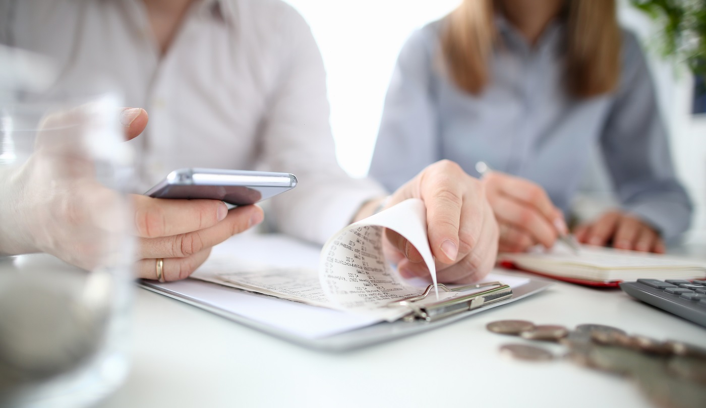 Young family man and woman checking financial figures