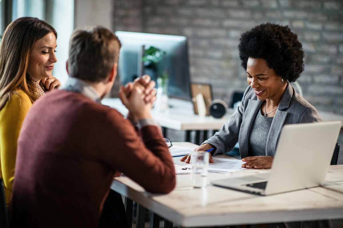 Woman counseling a couple at a desk