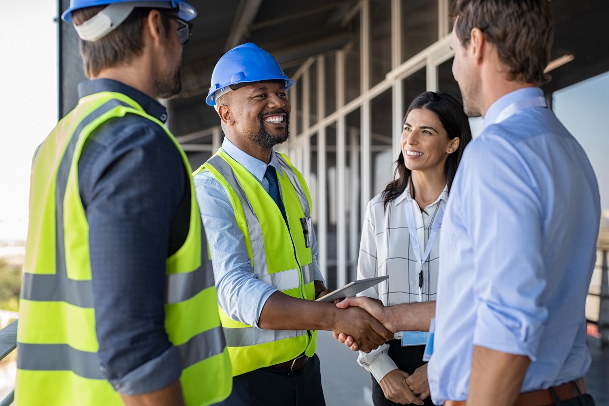 Engineer and businessman handshake at construction site 