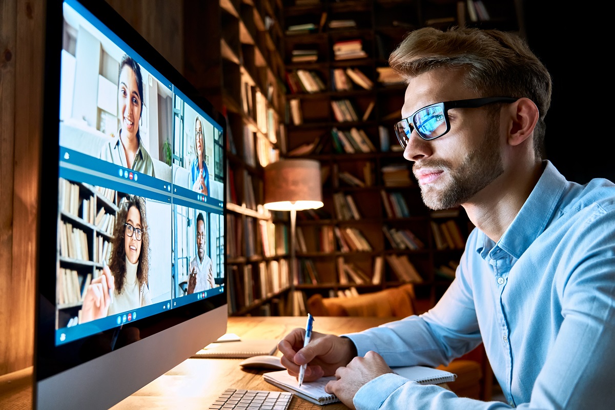 Business man having virtual team meeting on video conference call using computer