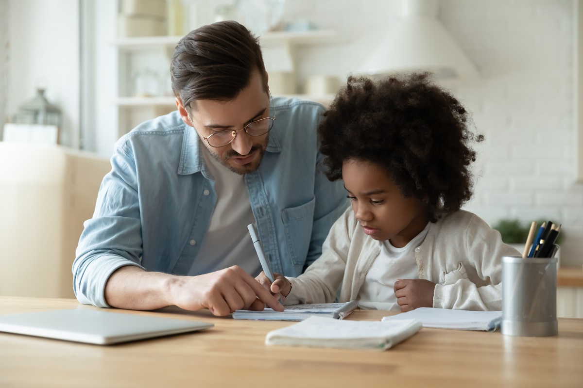 Dad helps daughter with homework