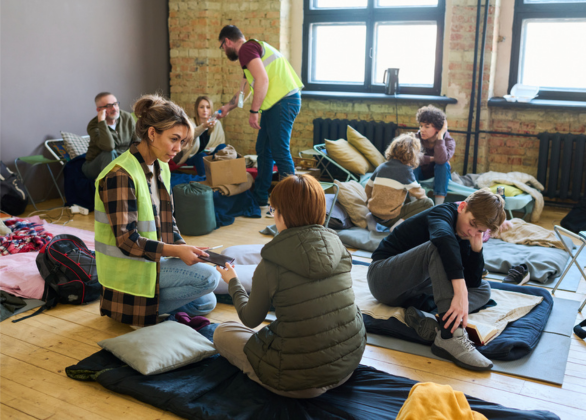 Workers helping people in a disaster shelter