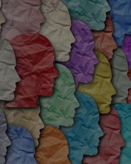 Crumpled paper silhouettes of faces in different colors