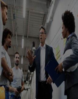 Company leader talking to employees while visiting a factory
