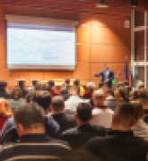 Speaker giving a talk in conference hall