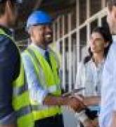Engineer and businessman handshake at construction site 