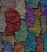 Crumpled paper silhouettes of faces in different colors