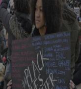 African American female holding Black Lives Matter sign