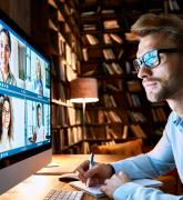 Business man having virtual team meeting on video conference call using computer