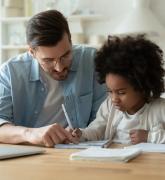 Dad helps daughter with homework