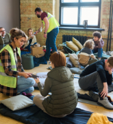 Workers helping people in a disaster shelter