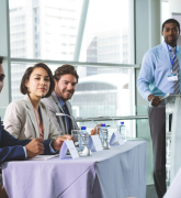 Five participants in a panel discussion setting
